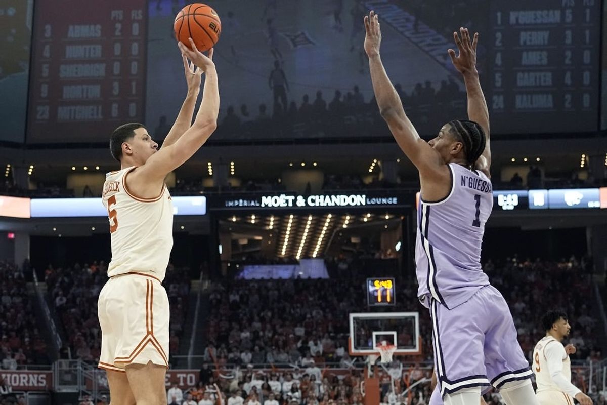 Feb 19, 2024; Austin, Texas, USA; Texas Longhorns forward Kadin Shedrick (5) shoots over Kansas State Wildcats forward David N'Guessan (1) during the first half at Moody Center.