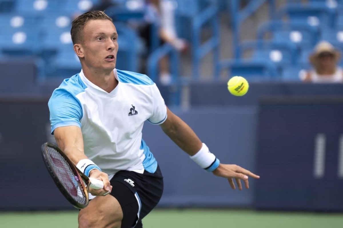 Aug 15, 2023; Mason, OH, USA; Jiri Lehecka, of Czech Republic, hits a return to Taylor Fritz, of the United States, during the Western & Southern Open at Lindner Family Tennis Center.