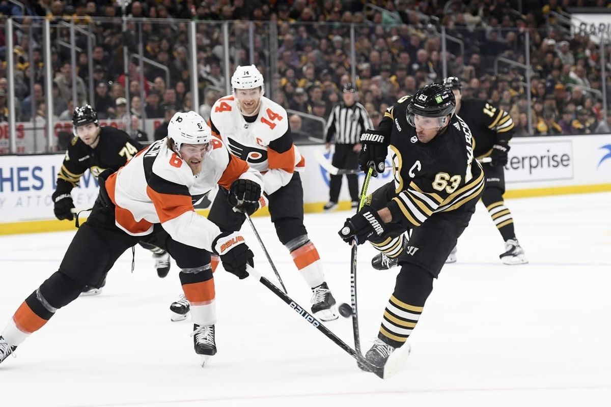 Mar 16, 2024; Boston, Massachusetts, USA; Boston Bruins left wing Brad Marchand (63) shoots the puck while Philadelphia Flyers defenseman Travis Sanheim (6) defends during the first period at TD Garden.