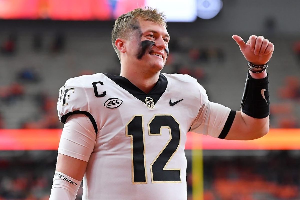 Nov 25, 2023; Syracuse, New York, USA; Wake Forest Demon Deacons quarterback Mitch Griffis (12) gestures to fans prior to the game against the Syracuse Orange at the JMA Wireless Dome.