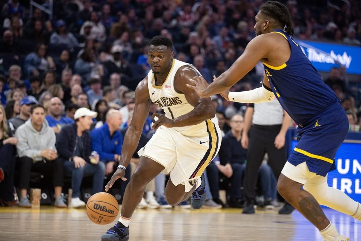Apr 12, 2024; San Francisco, California, USA; New Orleans Pelicans forward Zion Williamson (1) drives around Golden State Warriors forward Kevon Looney (5) during the first quarter at Chase Center.