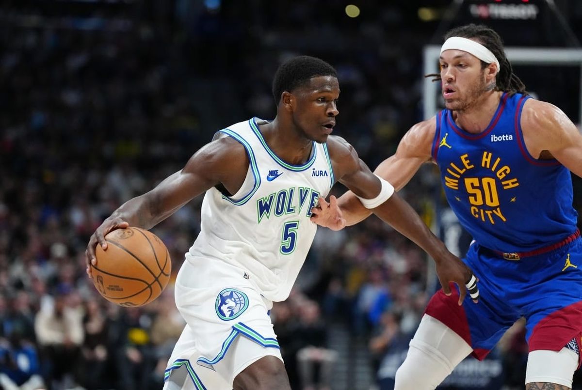 Mar 29, 2024; Denver, Colorado, USA; Minnesota Timberwolves guard Anthony Edwards (5) drives at Denver Nuggets forward Aaron Gordon (50) in the second quarter at Ball Arena.