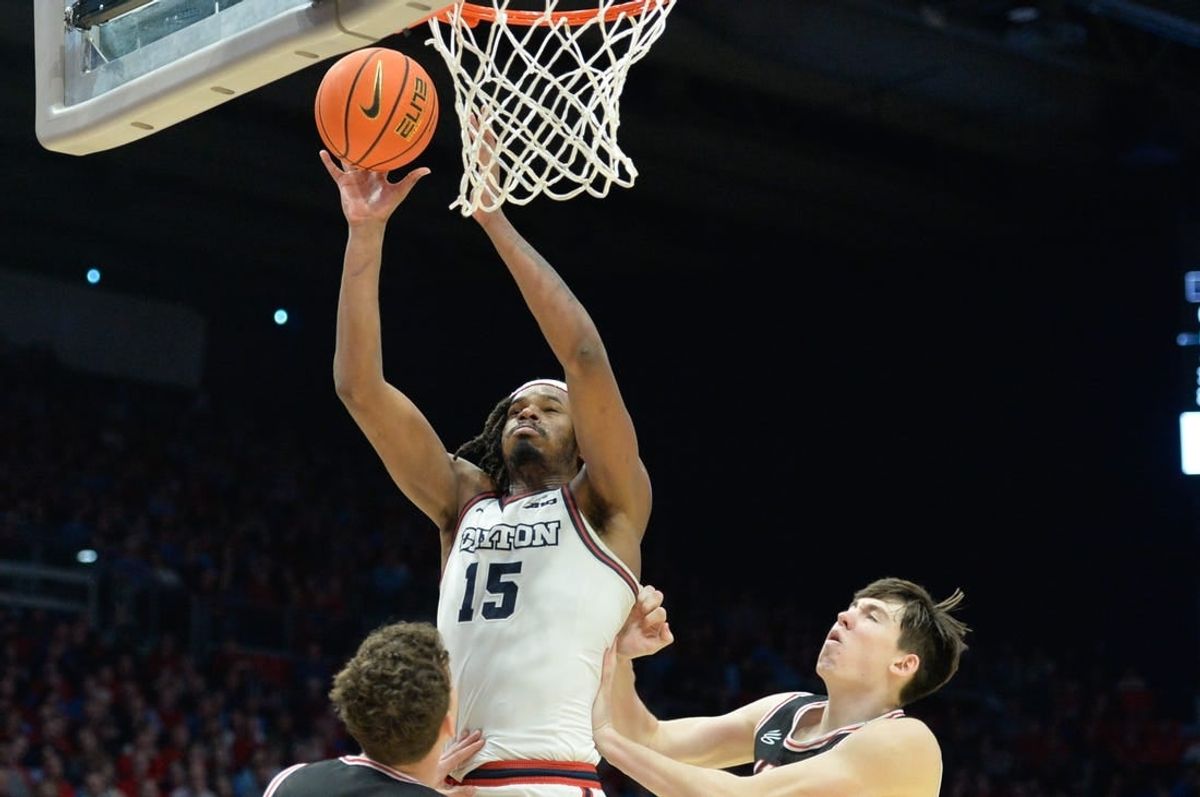 Feb 27, 2024; Dayton, Ohio, USA;  Dayton Flyers forward DaRon Holmes II (15) shoots the ball against Davidson Wildcats  guard Achile Spadone (3) and forward Sean Logan (15) during the second half of the game at University of Dayton Arena.