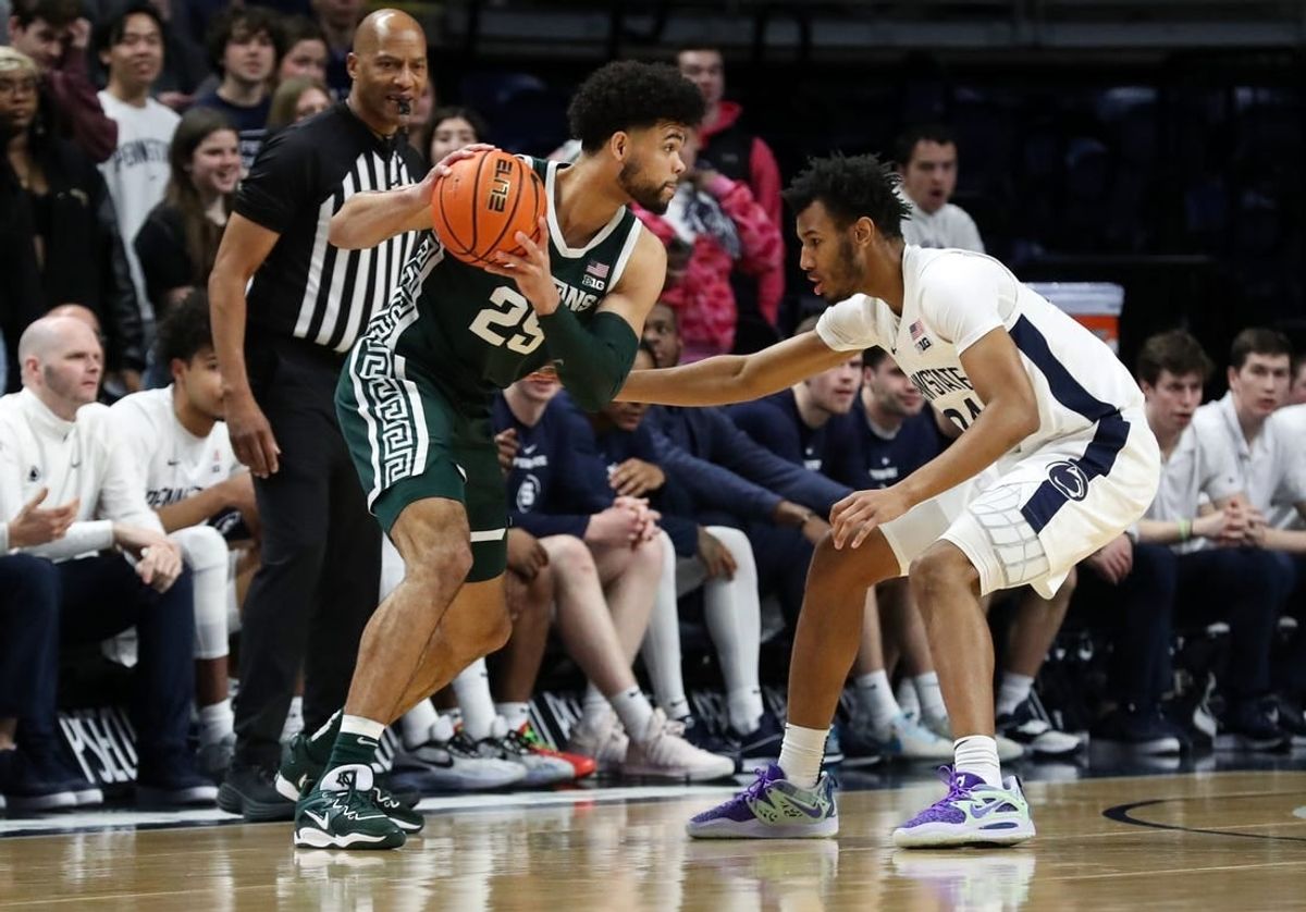 Feb 14, 2024; University Park, Pennsylvania, USA; Michigan State Spartans forward Malik Hall (25) holds the ball as Penn State Nittany Lions forward Zach Hicks (24) defends during the first half at Bryce Jordan Center.