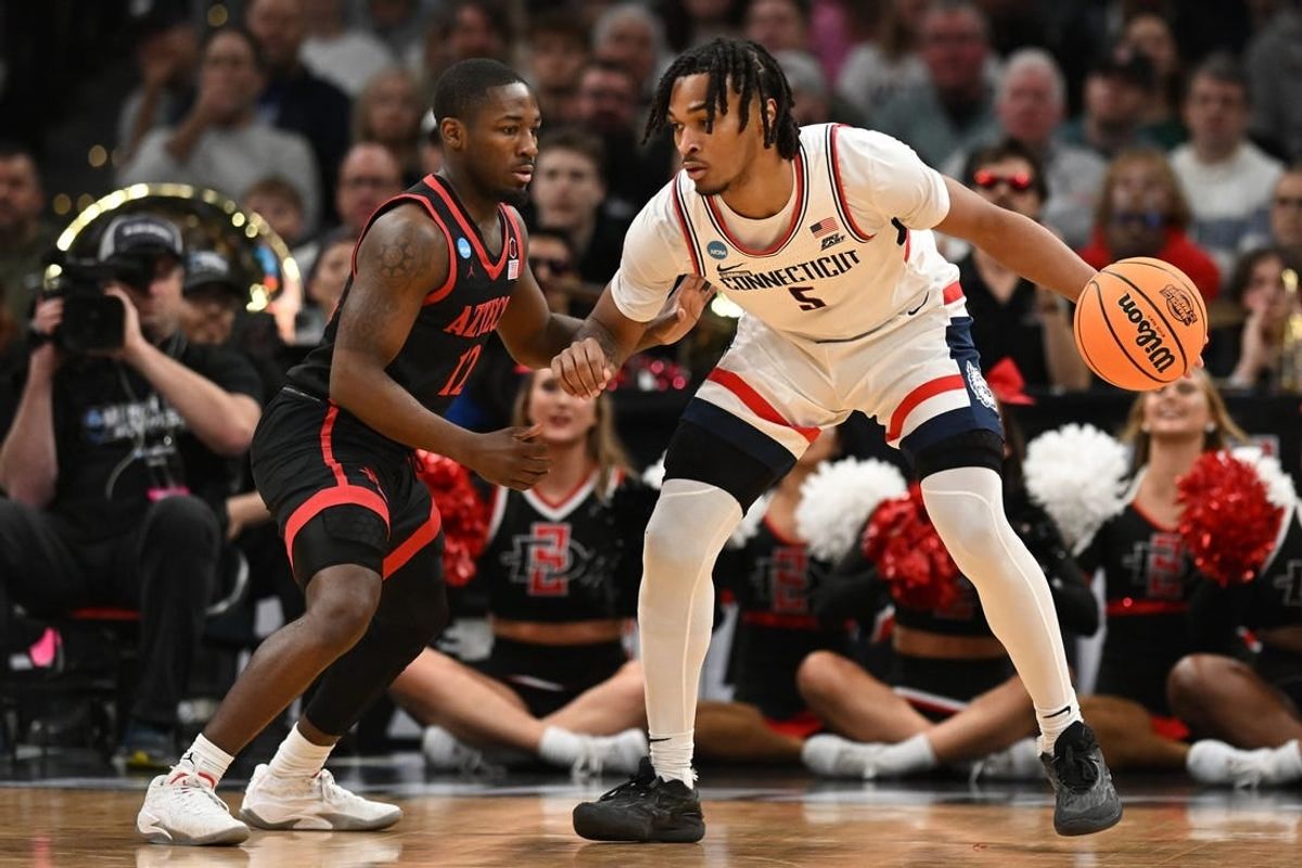 Mar 28, 2024; Boston, MA, USA; Connecticut Huskies guard Stephon Castle (5) dribbles the ball against San Diego State Aztecs guard Darrion Trammell (12) in the semifinals of the East Regional of the 2024 NCAA Tournament at TD Garden.