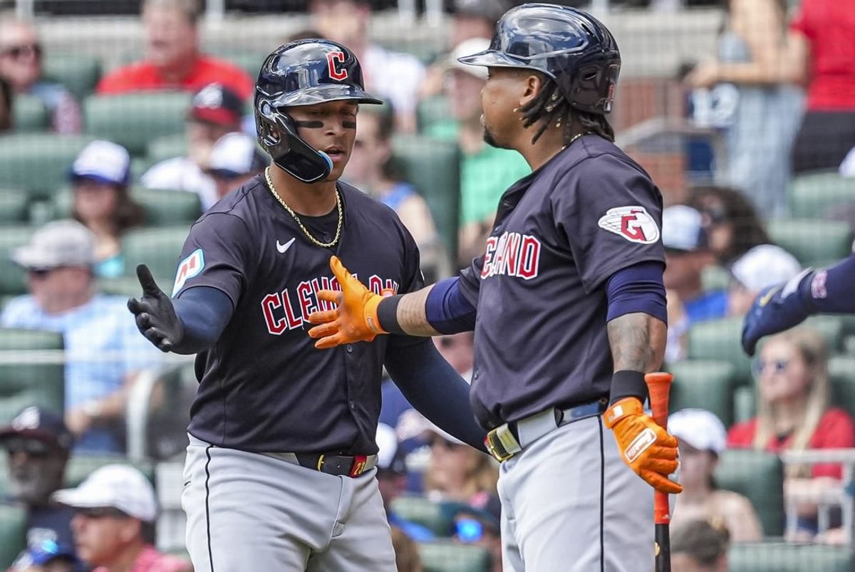Apr 26, 2024; Cumberland, Georgia, USA; Cleveland Guardians catcher Bo Naylor (23) reacts with third baseman Jose Ramirez (11) after scoring a run against the Atlanta Braves during the third inning at Truist Park.