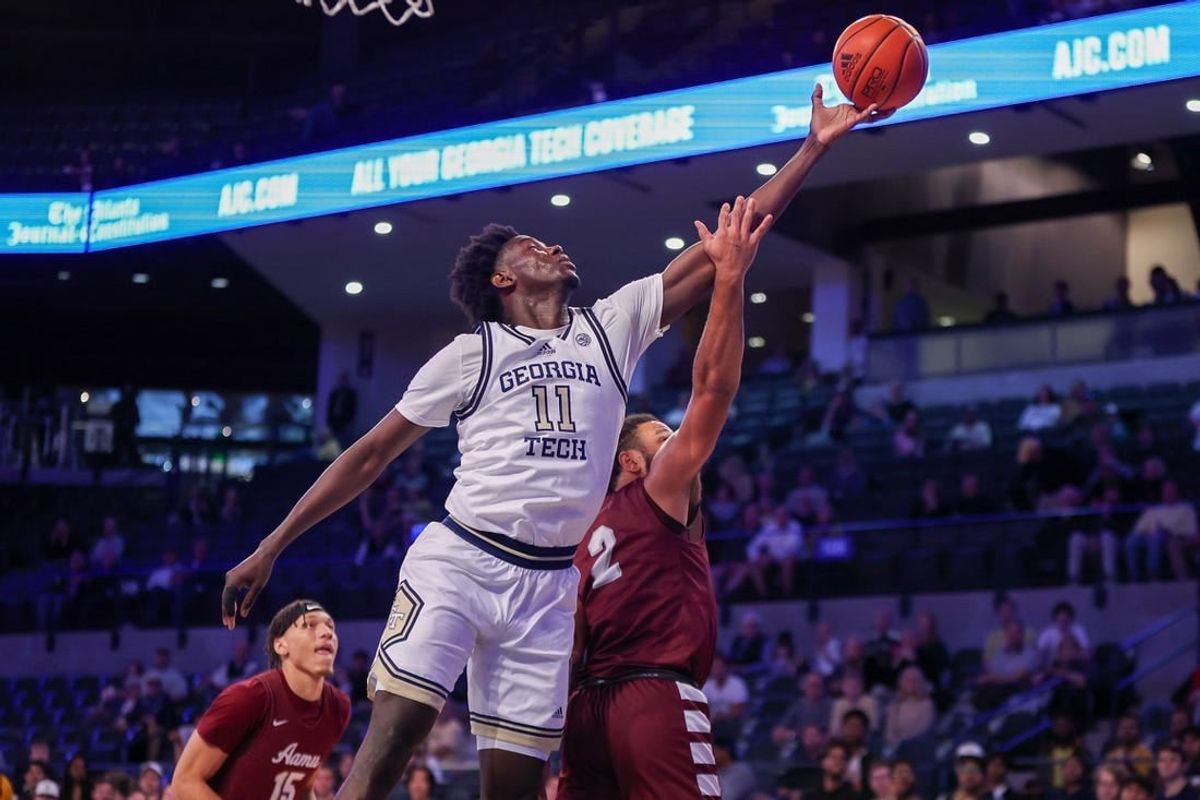 Dec 9, 2023; Atlanta, Georgia, USA; Georgia Tech Yellow Jackets forward Baye Ndongo (11) reaches for a rebound over Alabama A&M Bulldogs guard Omari Peek (2) in the first half at McCamish Pavilion.