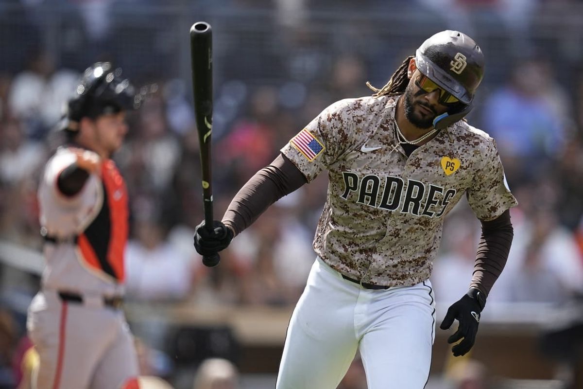 Mar 31, 2024; San Diego, California, USA; San Diego Padres right fielder Fernando Tatis Jr. (23) tosses his bat after hitting a ground ball during the fourth inning against the San Francisco Giants at Petco Park.