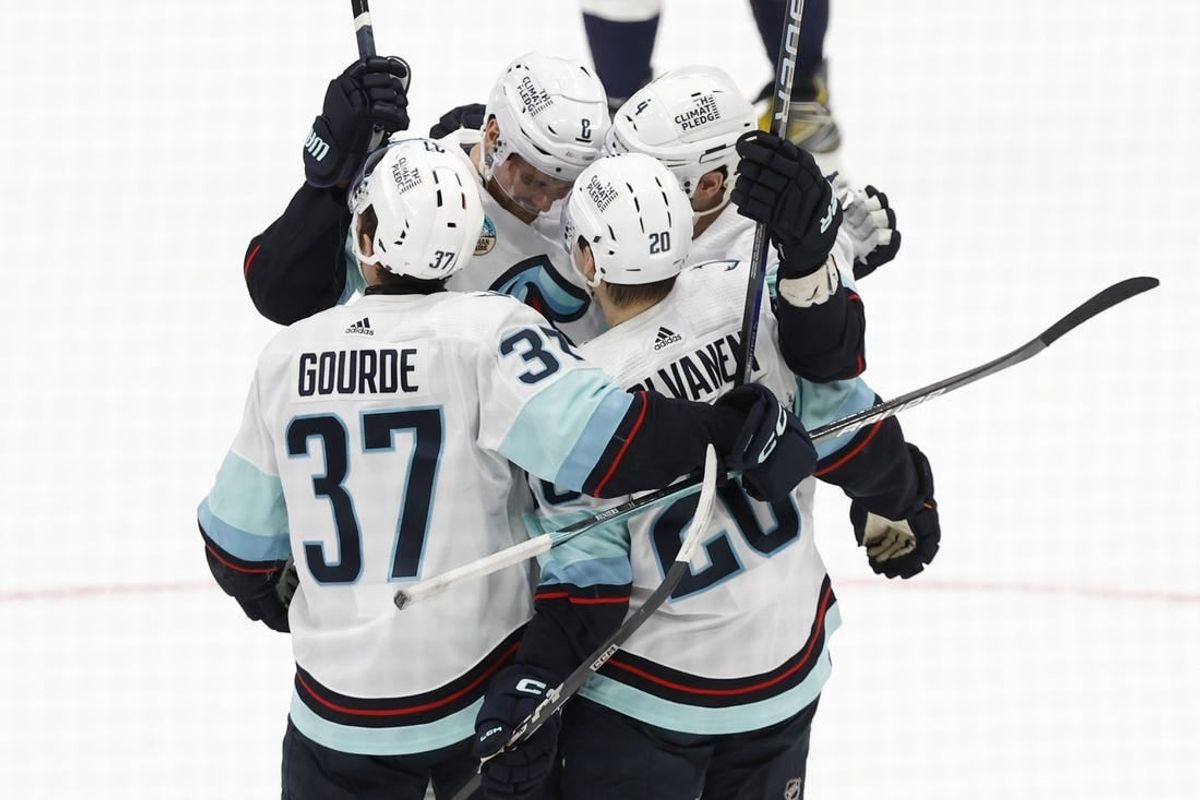 Jan 11, 2024; Washington, District of Columbia, USA; Seattle Kraken defenseman Justin Schultz (4) celebrates with teammates after scoring a goal against the Washington Capitals in the second period at Capital One Arena.