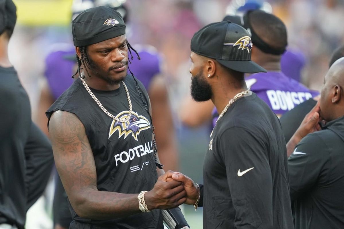 Aug 12, 2023; Baltimore, Maryland, USA; Baltimore Ravens quarterback Lamar Jackson (left) greets wide receiver  Odell Beckham Jr (right) on the sideline during the first quarter against the Philadelphia Eagles at M&T Bank Stadium.