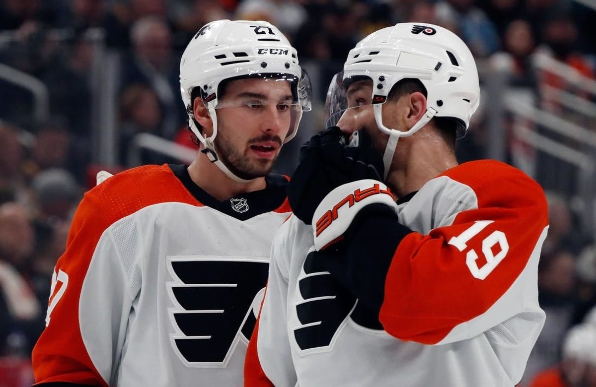 Feb 25, 2024; Pittsburgh, Pennsylvania, USA;  Philadelphia Flyers left wing Noah Cates (27) and right wing Garnet Hathaway (19) talk before a face-off against the Pittsburgh Penguins during the first period at PPG Paints Arena.