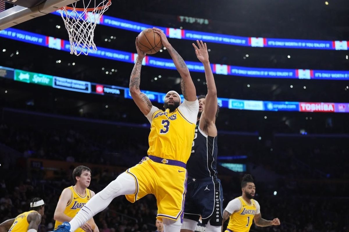 Jan 17, 2024; Los Angeles, California, USA; Los Angeles Lakers forward Anthony Davis (3) rebounds the ball against Dallas Mavericks center Dereck Lively II (2) in the first half at Crypto.com Arena.