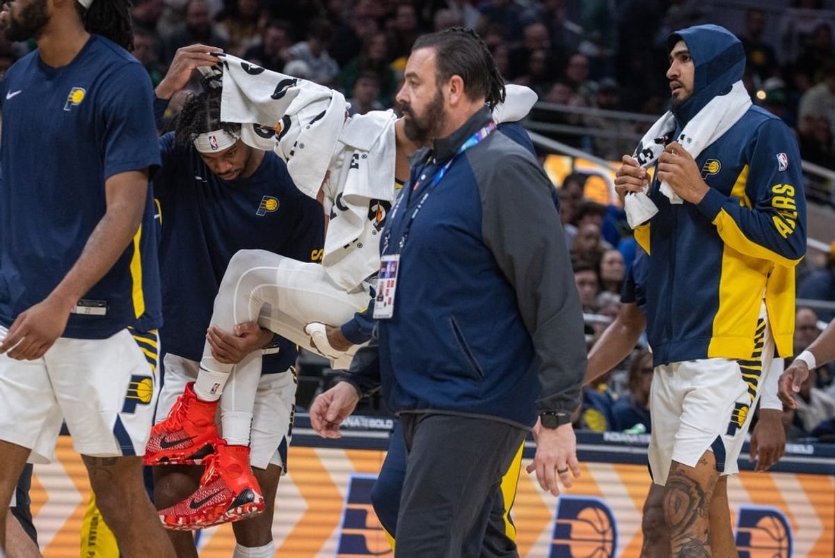 Jan 8, 2024; Indianapolis, Indiana, USA; Indiana Pacers guard Tyrese Haliburton (0) is carried off the court with apparent leg injury in the first half at Gainbridge Fieldhouse.