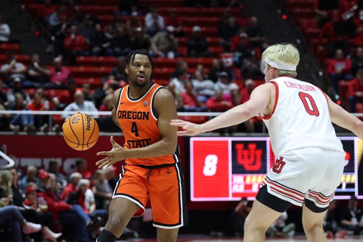 Jan 18, 2024; Salt Lake City, Utah, USA; Oregon State Beavers guard Dexter Akanno (4) looks to pass the ball on Utah Utes guard Hunter Erickson (0) during the first half at Jon M. Huntsman Center.