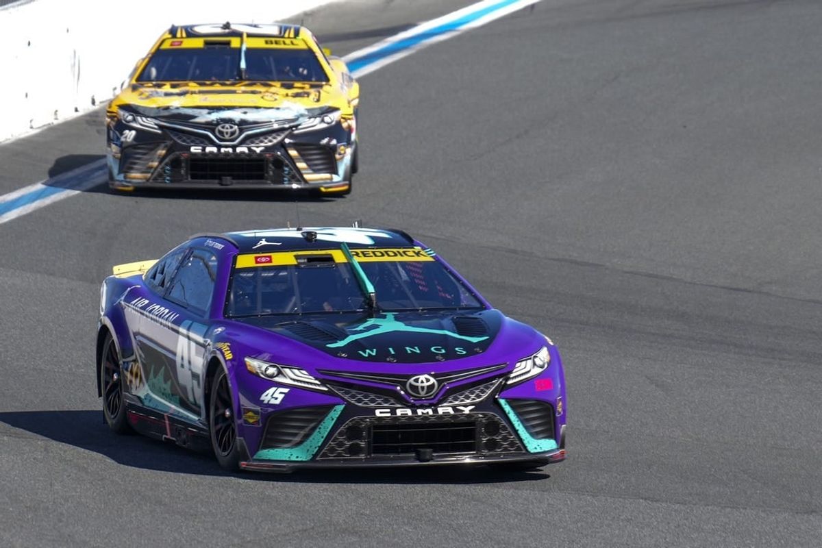 Oct 8, 2023; Concord, North Carolina, USA;  NASCAR Cup Series driver Tyler Reddick (45) leads driver Christopher Bell (20) out of turn eight during the Bank of America Roval 400 at Charlotte Motor Speedway Road Course.