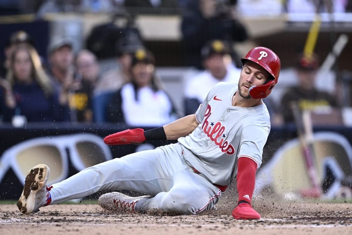 Apr 27, 2024; San Diego, California, USA; Philadelphia Phillies shortstop Trea Turner (7) slides home to score a run during the fifth inning against the San Diego Padres at Petco Park.
