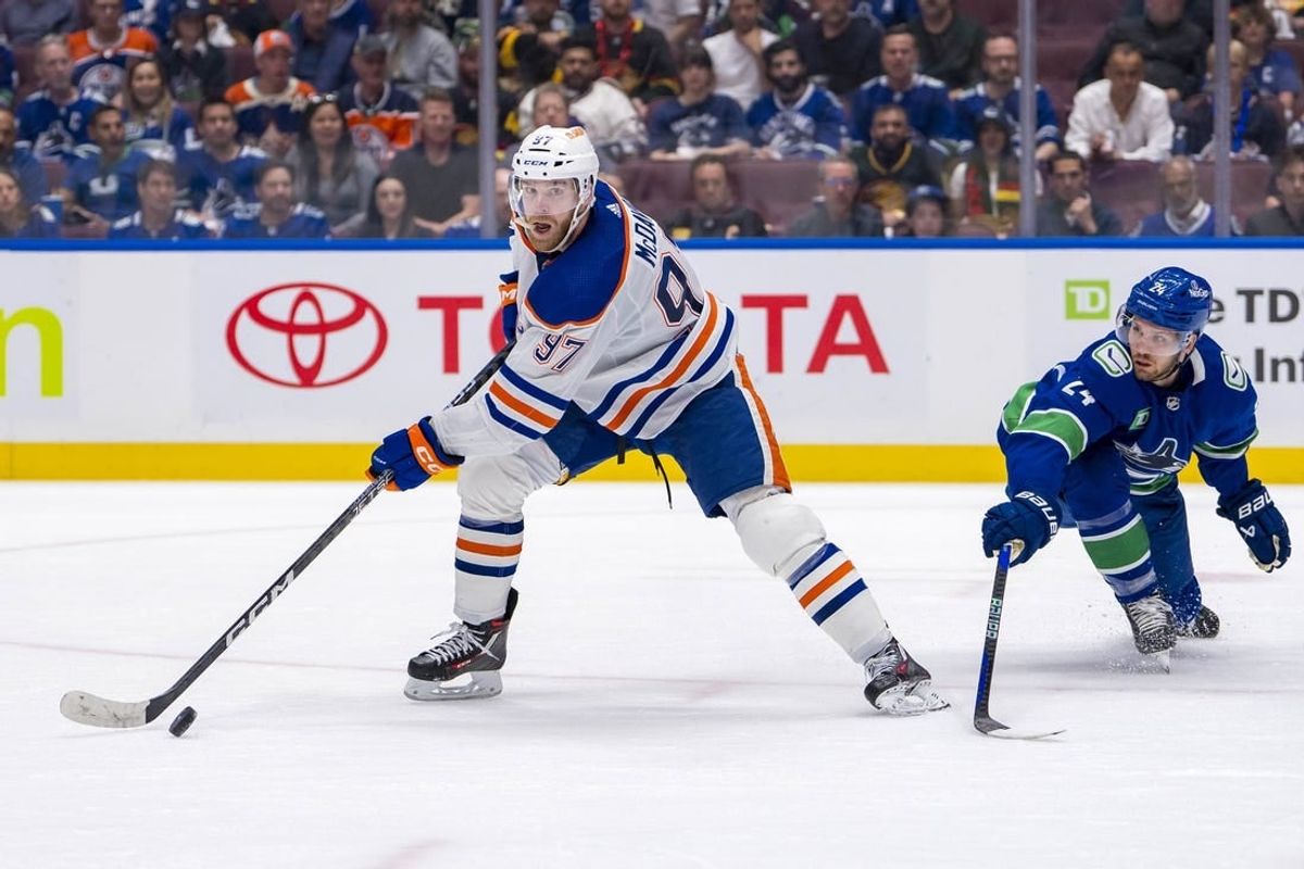 May 10, 2024; Vancouver, British Columbia, CAN; Vancouver Canucks forward Pius Suter (24) defends against Edmonton Oilers forward Connor McDavid (97) during the second period in game two of the second round of the 2024 Stanley Cup Playoffs at Rogers Arena.