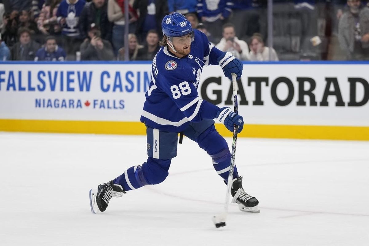 Nov 10, 2023; Toronto, Ontario, CAN; Toronto Maple Leafs forward William Nylander (88) shoots the puck against the Calgary Flames during the overtime shootout at Scotiabank Arena.