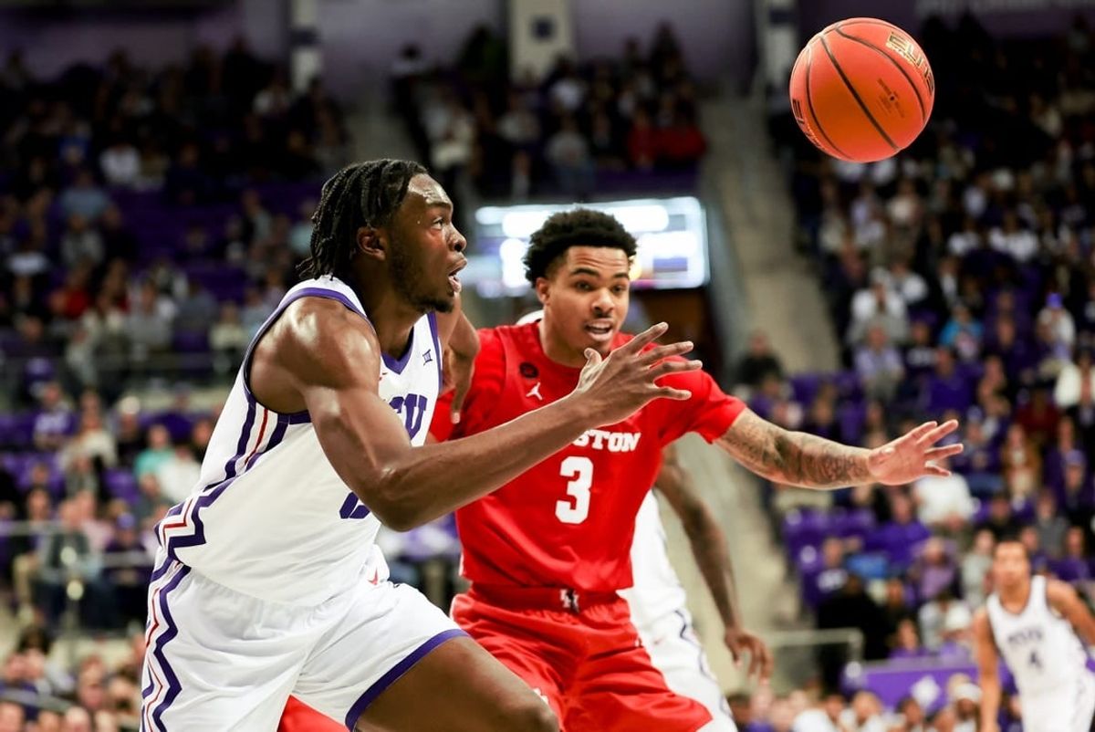 Jan 13, 2024; Fort Worth, Texas, USA;  TCU Horned Frogs center Ernest Udeh Jr. (8) and Houston Cougars guard Ramon Walker Jr. (3) go for a loose ball during the first half at Ed and Rae Schollmaier Arena.