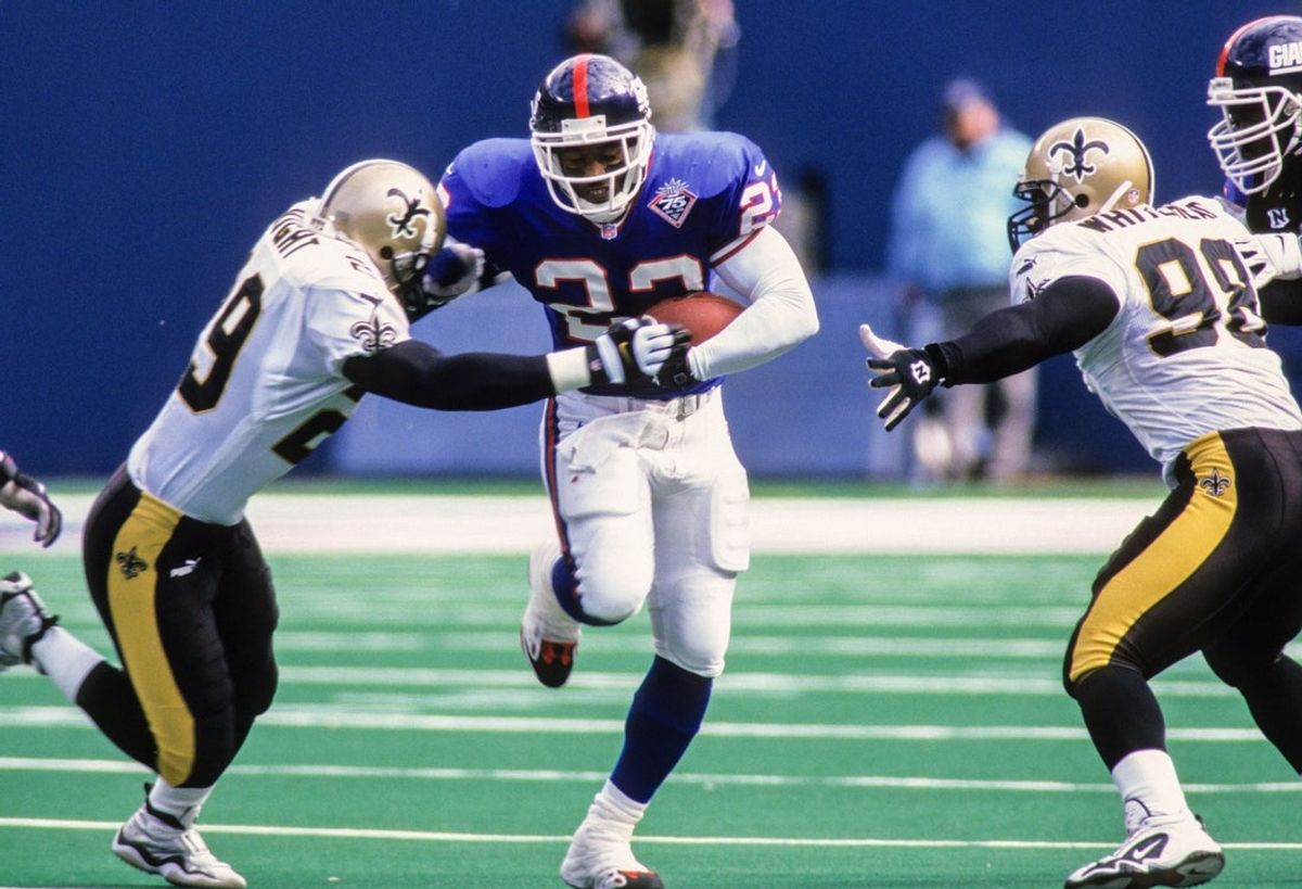 Oct 24, 1999; East Rutherford, NJ, USA; FILE PHOTO; New York Giants running back LeShon Johnson (23) carries the ball against New Orleans Saints safety Sammy Knight (29) and defensive end Willie Whitehead (98) at Giants Stadium. Mandatory Credit: Lou Capozzola-USA TODAY NETWORK