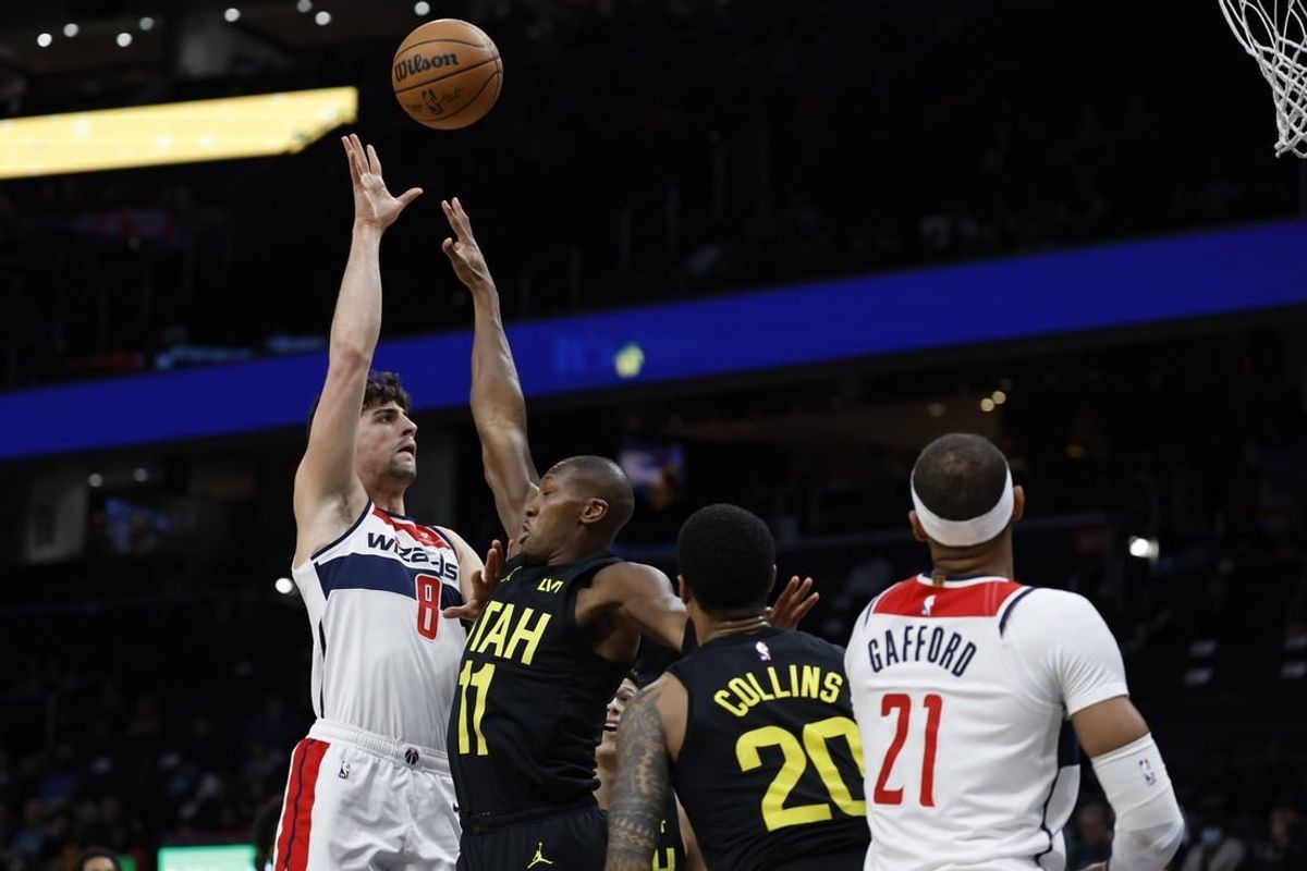 Jan 25, 2024; Washington, District of Columbia, USA; Washington Wizards forward Deni Avdija (8) shoots the ball over Utah Jazz guard Kris Dunn (11) in the first half at Capital One Arena.
