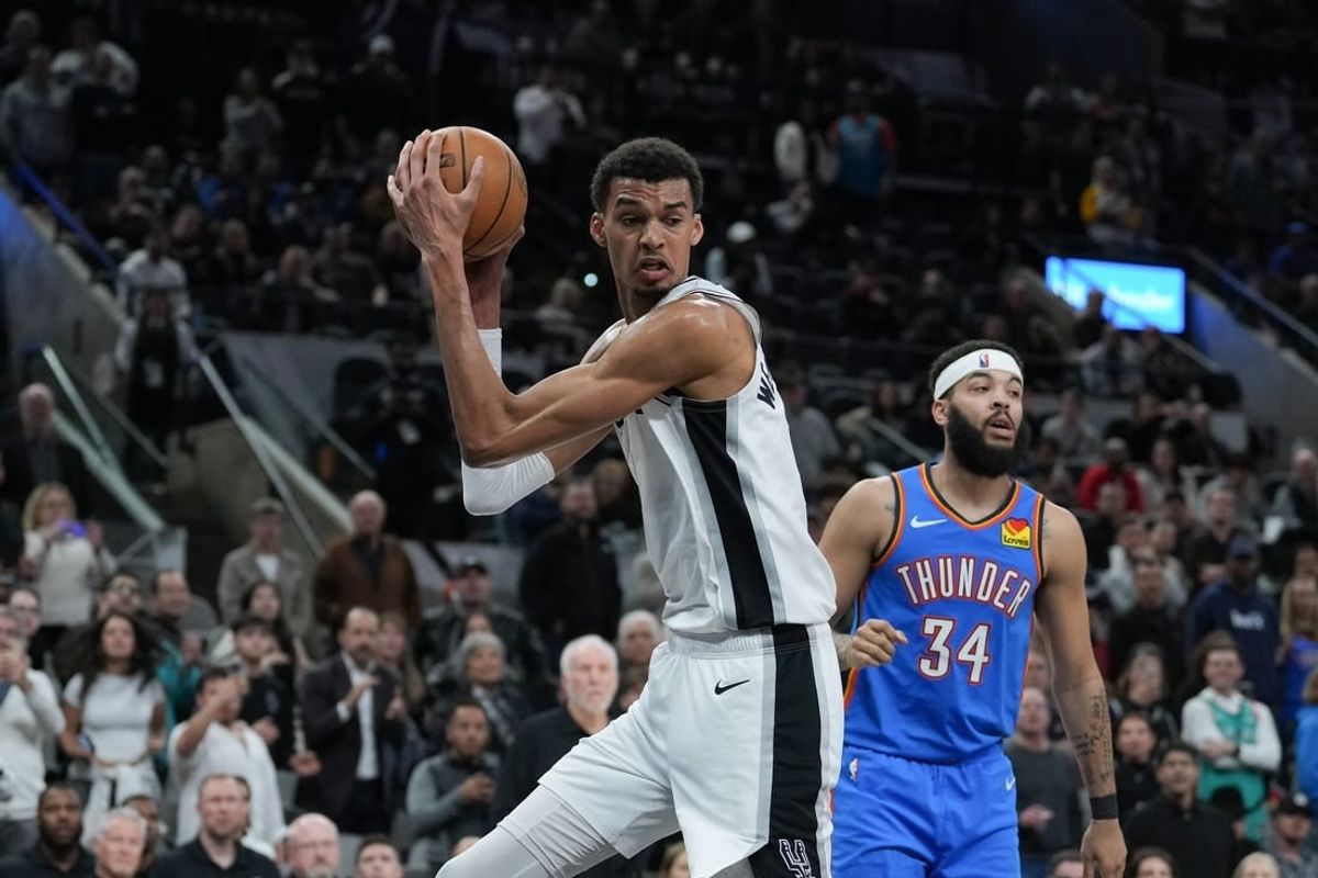 Feb 29, 2024; San Antonio, Texas, USA;  San Antonio Spurs center Victor Wembanyama (1) rebounds in front of Oklahoma City Thunder forward Kenrich Williams (34) in the second half at Frost Bank Center.