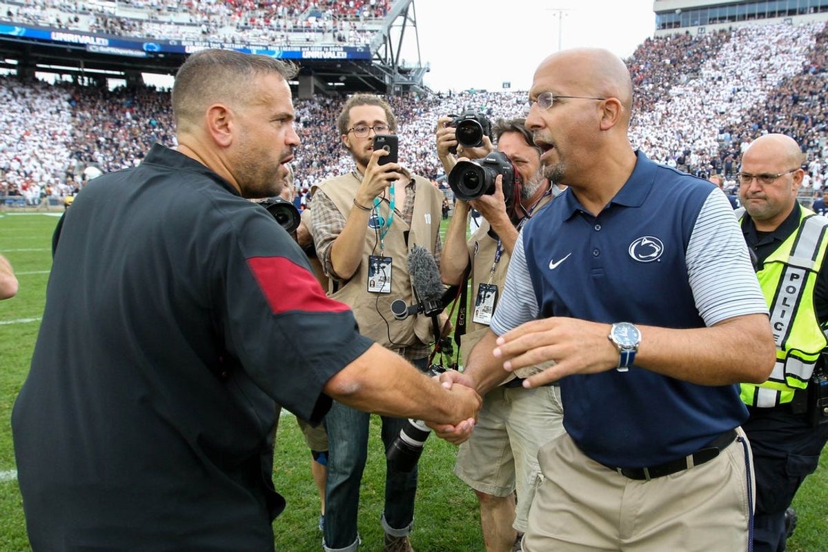 Sep 17, 2016; University Park, PA, USA; Penn State Nittany Lions head coach James Franklin (right) shakes hands with Temple Owls head coach Matt Rhule (left) following the completion of the game at Beaver Stadium. Penn State defeated Temple 34-27. Mandatory Credit: Matthew O'Haren-Imagn Images