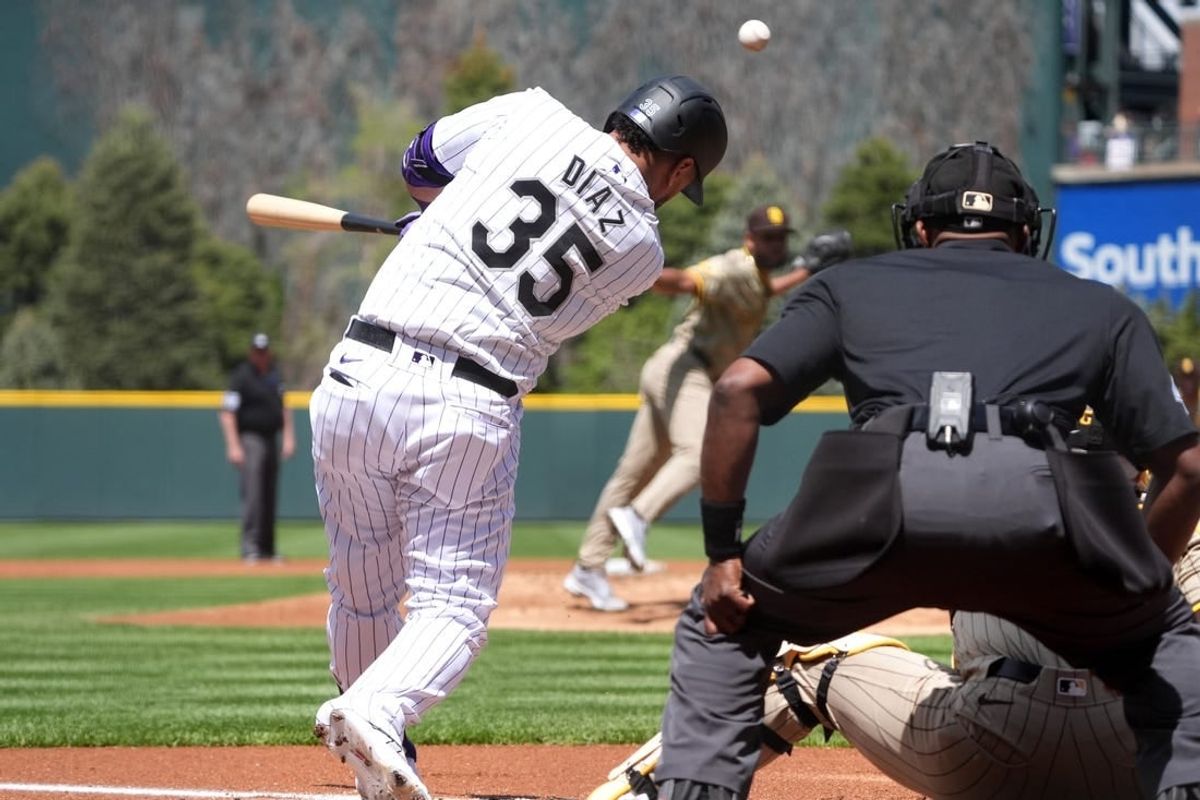 Apr 25, 2024; Denver, Colorado, USA; Colorado Rockies designated hitter Elias Díaz (35) RBI singles in the first inning against the San Diego Padres at Coors Field.