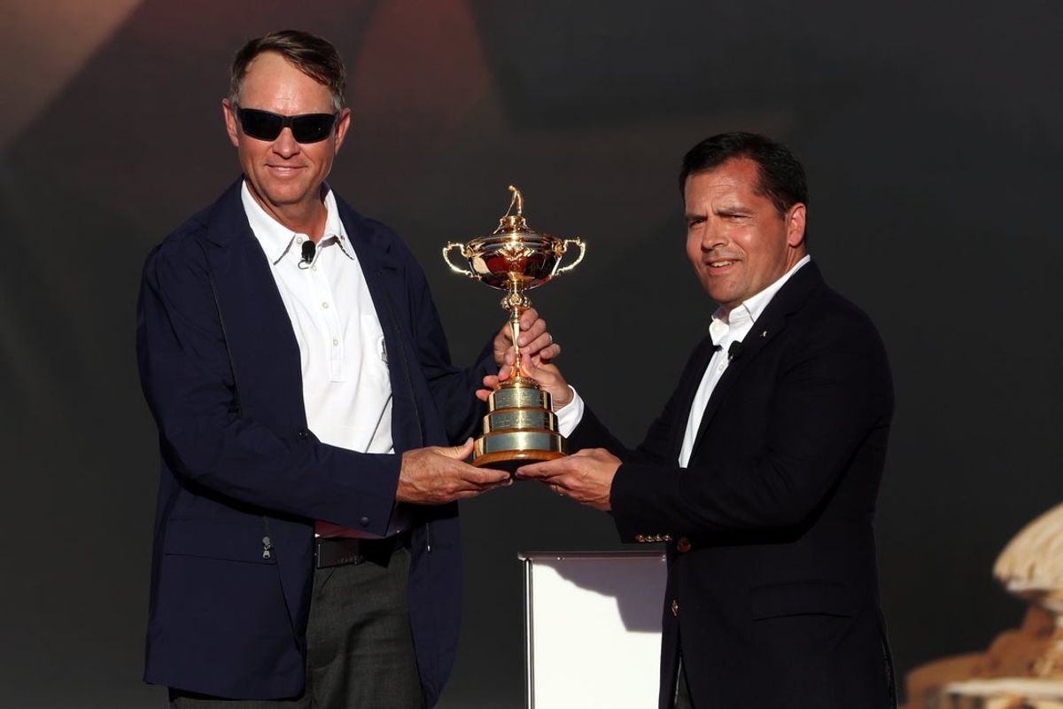Oct 2, 2016; Chaska, MN, USA; Team USA captain Davis Love III is presented the Ryder Cup by PGA of America president Derek Sprague during the closing ceremonies after the single matches in 41st Ryder Cup at Hazeltine National Golf Club. Mandatory Credit: Rob Schumacher-Imagn Images
