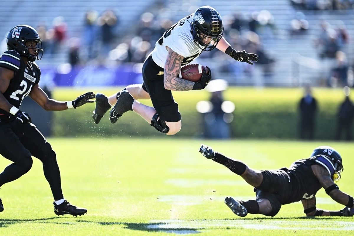 Nov 18, 2023; Evanston, Illinois, USA;  Purdue Boilermakers tight end Garrett Miller (88) is tripped up by Northwestern Wildcats defensive back Jaheem Joseph (3) after a pass reception in the second quarter at Ryan Field.