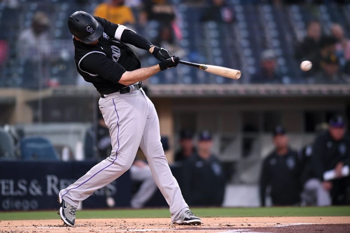 May 18, 2021; San Diego, California, USA; Colorado Rockies first baseman CJ Cron (25) singles against the San Diego Padres during the second inning at Petco Park.