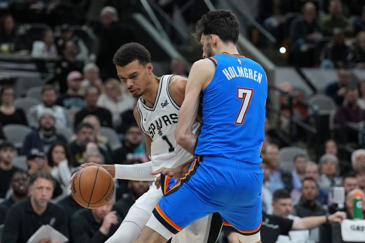 Feb 29, 2024; San Antonio, Texas, USA;  San Antonio Spurs center Victor Wembanyama (1) drives in against Oklahoma City Thunder forward Chet Holmgren (7) in the first half at Frost Bank Center.