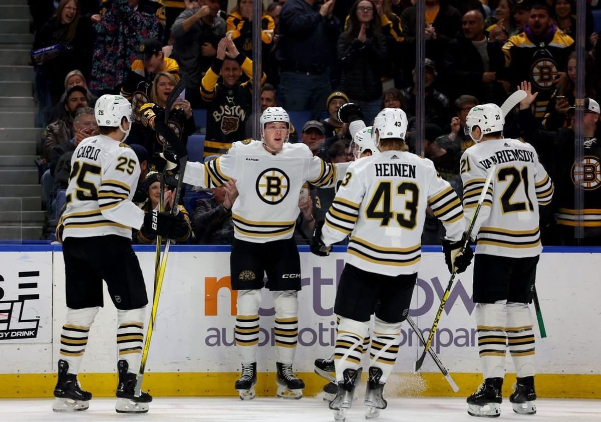 Dec 27, 2023; Buffalo, New York, USA;  Boston Bruins defenseman Mason Lohrei (6) celebrates his goal with teammates during the first period against the Buffalo Sabres at KeyBank Center.