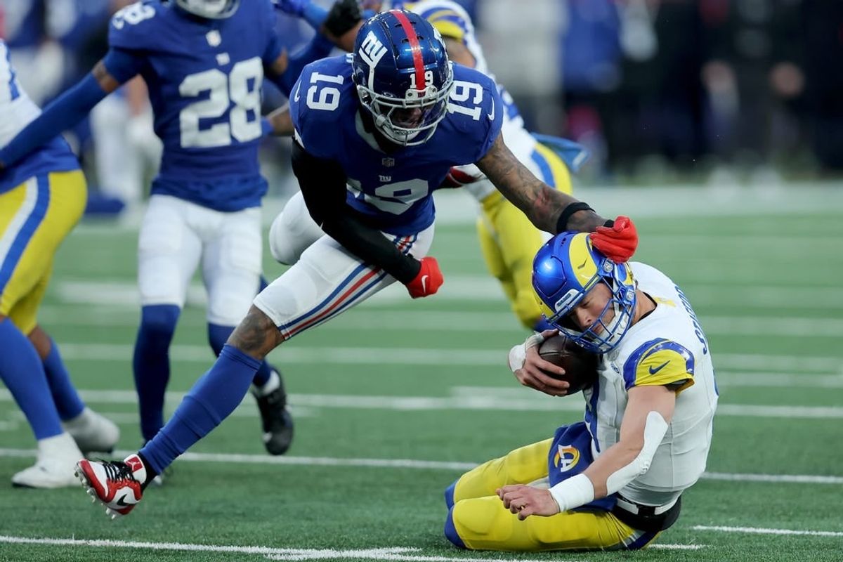 Dec 31, 2023; East Rutherford, New Jersey, USA; Los Angeles Rams quarterback Matthew Stafford (9) is sacked by New York Giants safety Isaiah Simmons (19) during the fourth quarter at MetLife Stadium.