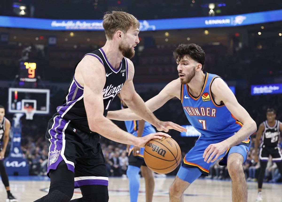 Apr 9, 2024; Oklahoma City, Oklahoma, USA; Sacramento Kings forward Domantas Sabonis (10) drives to the basket as Oklahoma City Thunder forward Chet Holmgren (7) defends during the first quarter at Paycom Center.