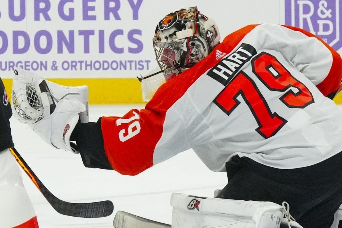 Nov 15, 2023; Raleigh, North Carolina, USA; Philadelphia Flyers goaltender Carter Hart (79) reaches out to make glove save against the Carolina Hurricanes during the first period at PNC Arena.
