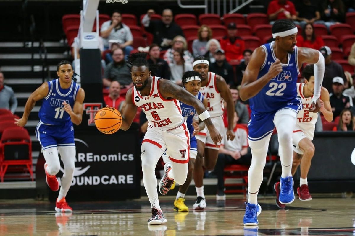 Dec 21, 2023; Lubbock, Texas, USA;  Texas Tech Red Raiders guard Joe Toussaint (6) brings the ball up court against Texas-Arlington Mavericks forward Shemar Wilson (22) and forward Dwayne Korma (11) in the first half at United Supermarkets Arena.