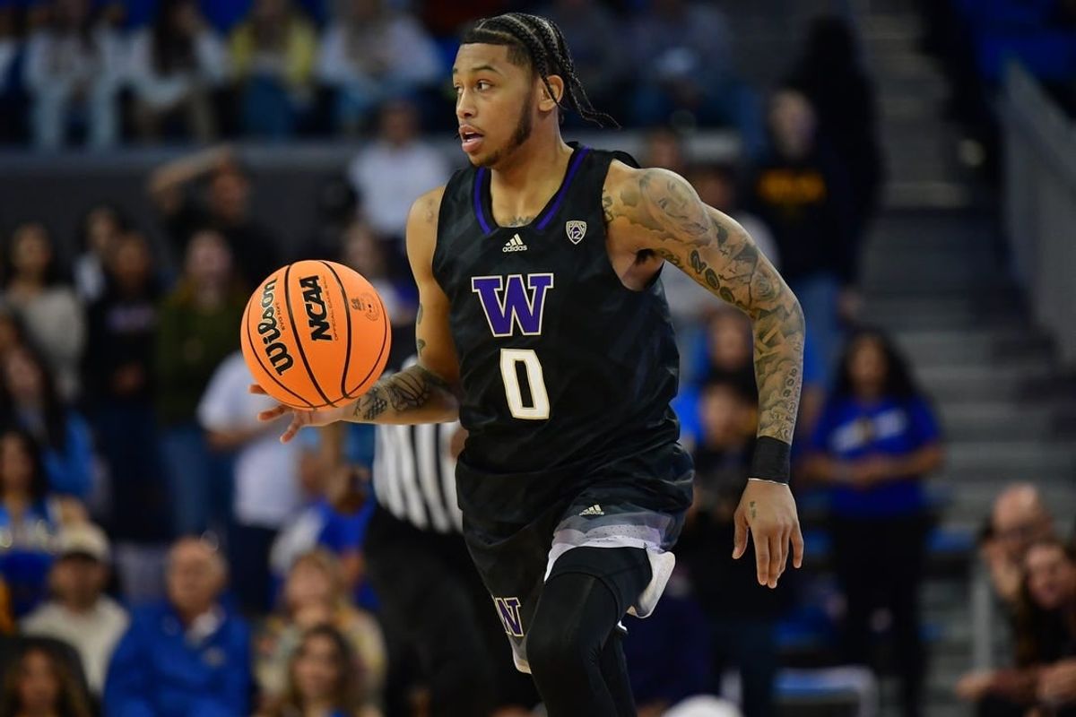 January 14, 2024; Los Angeles, California, USA; Washington Huskies guard Koren Johnson (0) brings the ball up court against the UCLA Bruins during the first half at Pauley Pavilion.