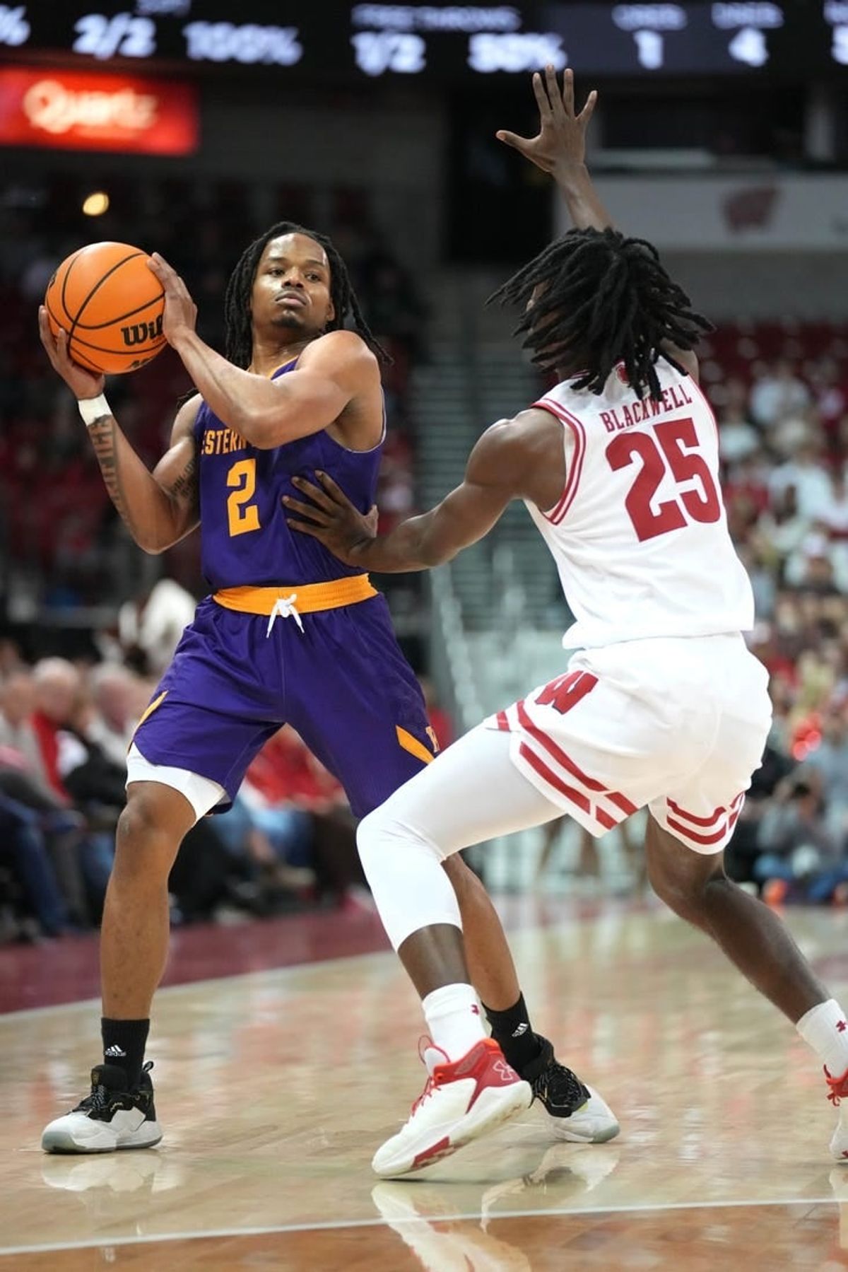 Nov 27, 2023; Madison, Wisconsin, USA;  Western Illinois Leathernecks guard Ryan Myers (2) looks to pass the ball while defended by Wisconsin Badgers guard John Blackwell (25) during the first half at the Kohl Center.