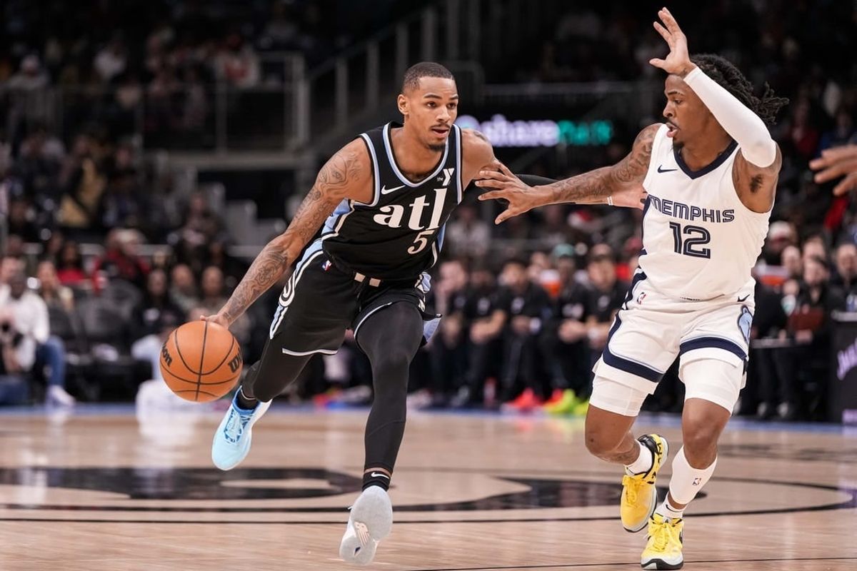 Dec 23, 2023; Atlanta, Georgia, USA; Atlanta Hawks guard Dejounte Murray (5) dribbles against Memphis Grizzlies guard Ja Morant (12) during the first half at State Farm Arena.