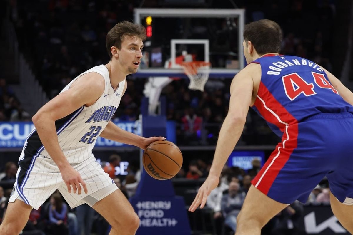 Feb 4, 2024; Detroit, Michigan, USA; Orlando Magic forward Franz Wagner (22) is defended by Detroit Pistons forward Bojan Bogdanovic (44) in the first half at Little Caesars Arena.
