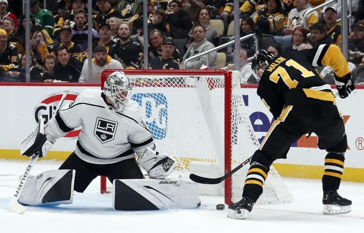 Feb 18, 2024; Pittsburgh, Pennsylvania, USA;  Los Angeles Kings goaltender Cam Talbot (39) makes a save against Pittsburgh Penguins center Evgeni Malkin (71) during the first period at PPG Paints Arena.