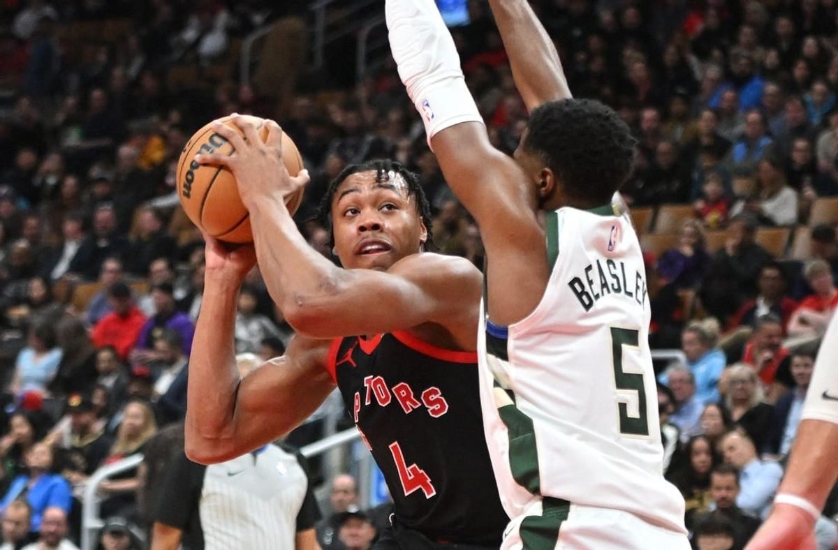 Nov 15, 2023; Toronto, Ontario, CAN;  Toronto Raptors forward Scottie Barnes (4) looks for a way past Milwaukee Bucks guard Malik Beasley (5) in the first half at Scotiabank Arena.