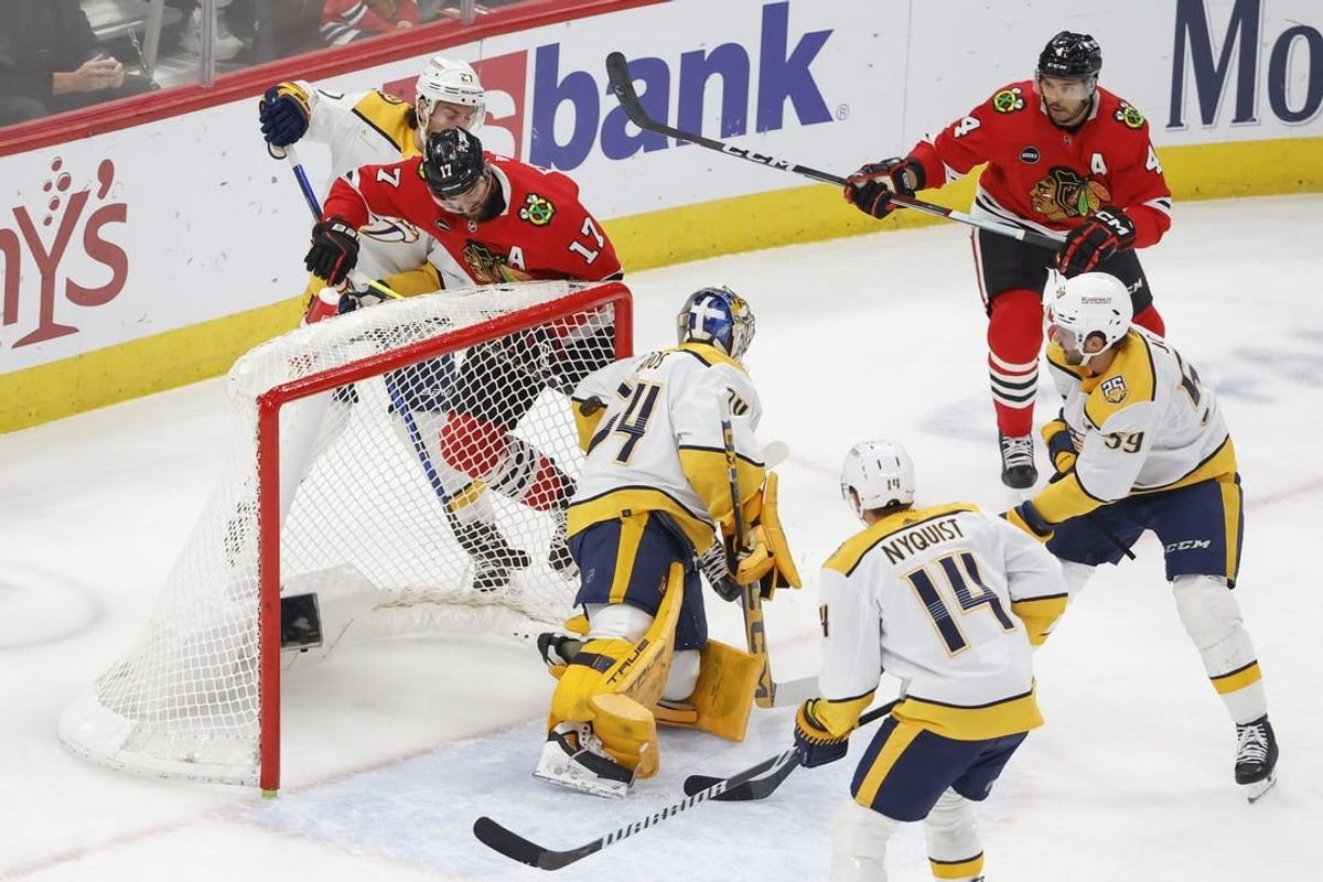 Dec 5, 2023; Chicago, Illinois, USA; Chicago Blackhawks left wing Nick Foligno (17) scores against Nashville Predators goaltender Juuse Saros (74) during the first period at United Center.