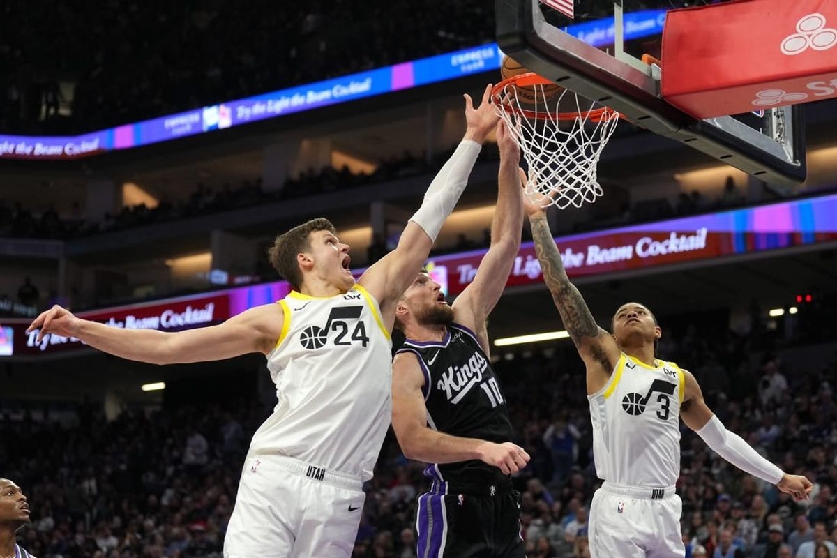 Mar 31, 2024; Sacramento, California, USA; Sacramento Kings forward Domantas Sabonis (10) shoots against Utah Jazz center Walker Kessler (24) and guard Keyonte George (3) during the second quarter at Golden 1 Center.