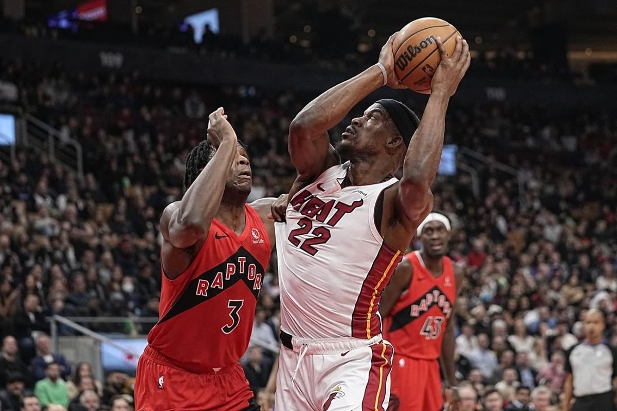 Dec 6, 2023; Toronto, Ontario, CAN; Miami Heat forward Jimmy Butler (22) tries to make a basket against Toronto Raptors forward O.G. Anunoby (3) during the first half at Scotiabank Arena.