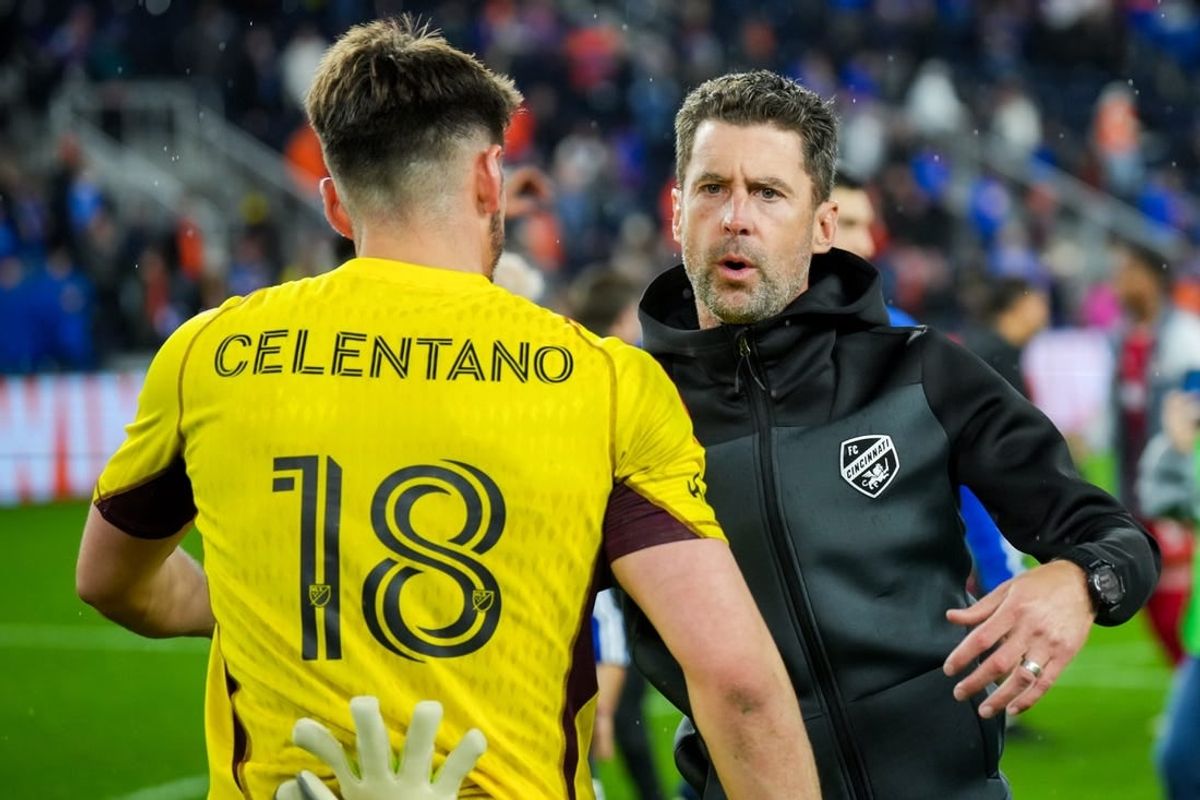 Oct 29, 2023; Cincinnati, OH, USA; FC Cincinnati head coach Pat Noonan hugs goalkeeper Roman Celentano (18) on the field after his team defeats the New York Red Bulls in game one in a round one match of the 2023 MLS Cup Playoffs at TQL Stadium.