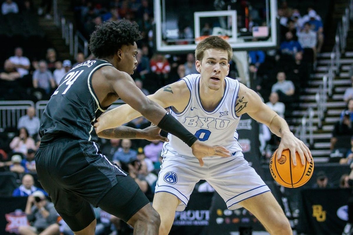 Mar 13, 2024; Kansas City, MO, USA; Brigham Young Cougars forward Noah Waterman (0) brings the ball up court around UCF Knights guard Jaylin Sellers (24) during the first half at T-Mobile Center.