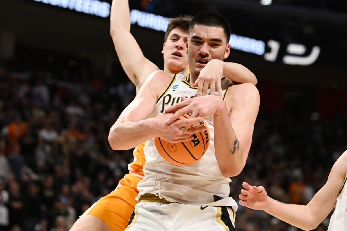Mar 31, 2024; Detroit, MI, USA; Purdue Boilermakers center Zach Edey (15) controls the ball defended by Tennessee Volunteers forward J.P. Estrella (13) in the second half during the NCAA Tournament Midwest Regional Championship- at Little Caesars Arena.