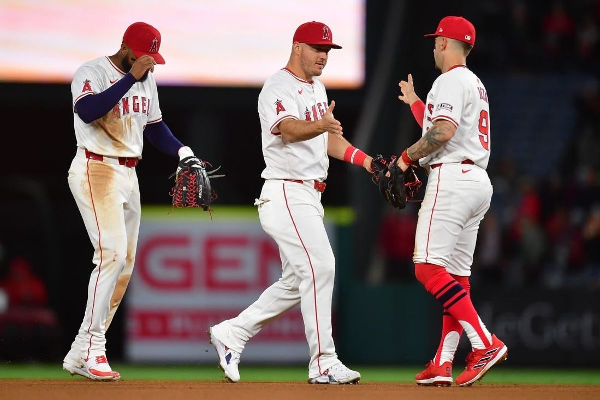 Apr 23, 2024; Anaheim, California, USA; Los Angeles Angels center fielder Mike Trout (27) right fielder Jo Adell (7) and shortstop Zach Neto (9) celebrate the victory against the Baltimore Orioles at Angel Stadium.
